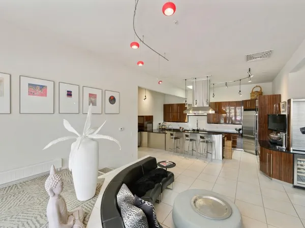 a living room with lots of furniture and kitchen view