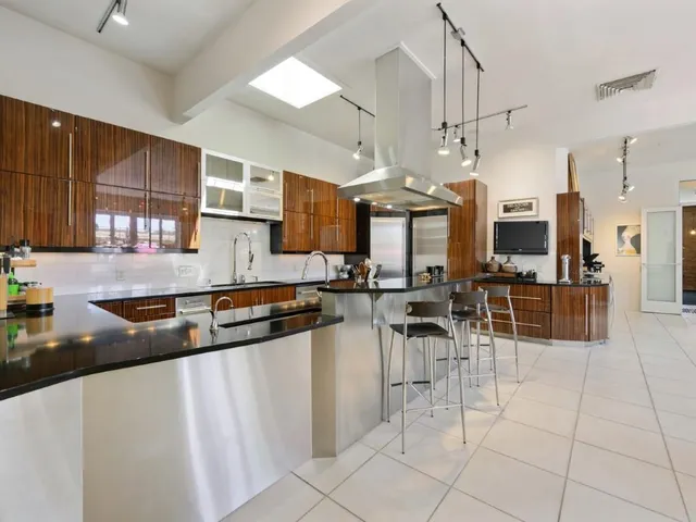 a kitchen with stainless steel appliances granite countertop a sink and cabinets