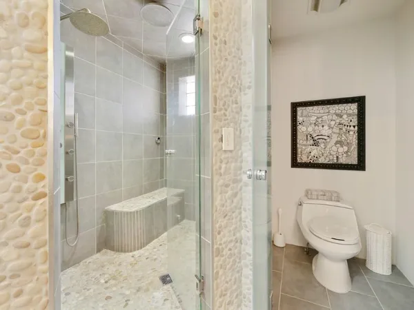 a white toilet sitting next to a bathroom sink