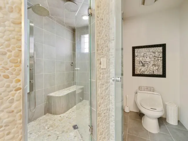 a white toilet sitting next to a bathroom sink