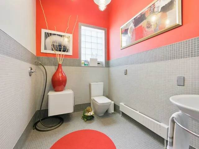 a bathroom with a toilet a sink and a mirror