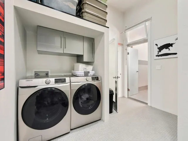 a utility room with closet dryer and washer