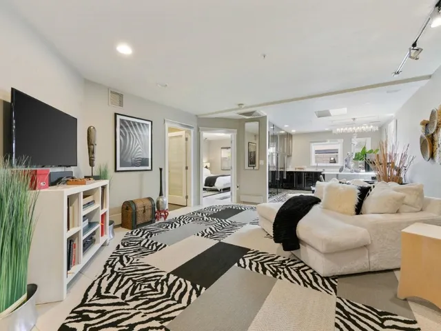 a kitchen with a dining table chairs sink and cabinets