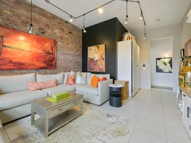 a living room with furniture and a chandelier