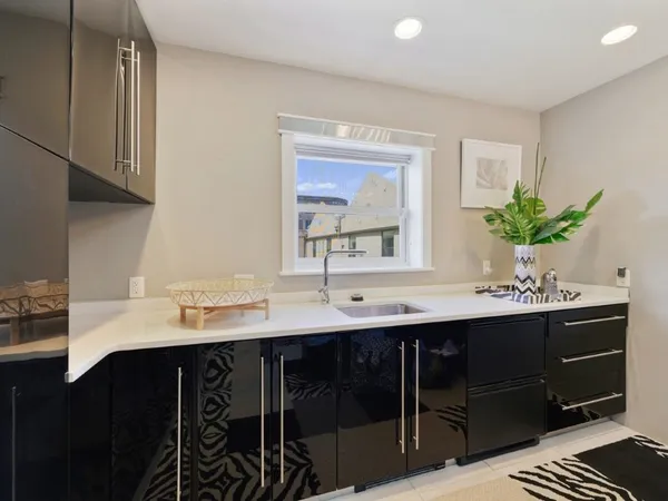 a bathroom with a glass door shower and a sink