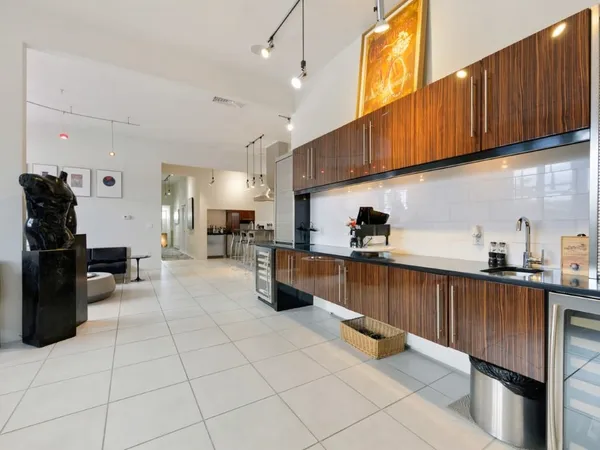 a kitchen with stainless steel appliances kitchen island granite countertop a refrigerator a stove a sink and dishwasher