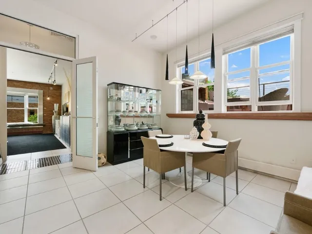 a view of a dining room with furniture large window and chandelier