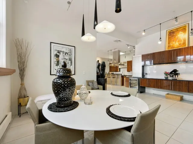 a dining room with furniture and a chandelier