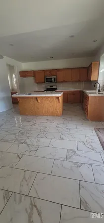 a kitchen with a sink a window and cabinets