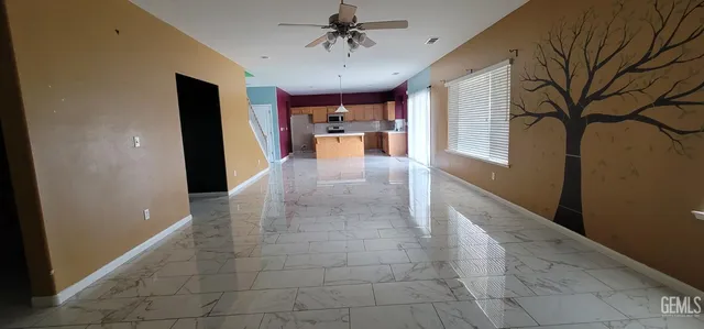 a view of hallway with furniture and a chandelier