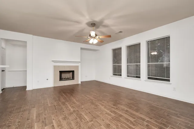 a view of an empty room with glass door and a window