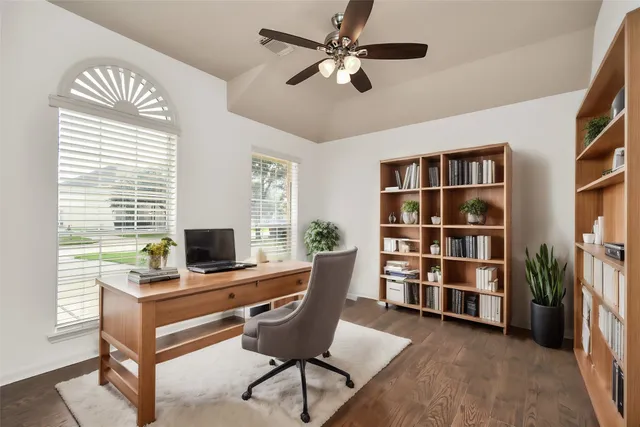 a view of a workspace with furniture and a window