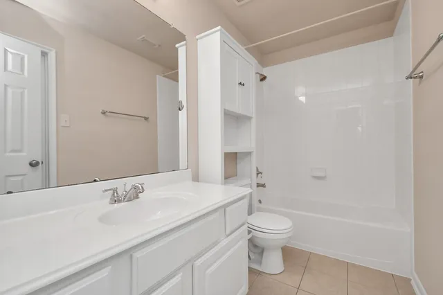 a bathroom with a sink toilet tub and shower