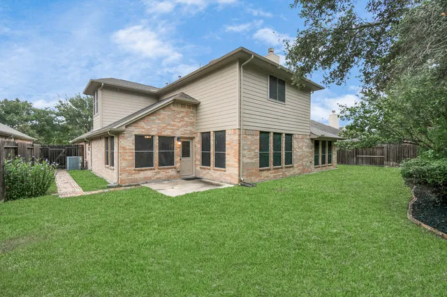 a front view of a house with a yard and porch