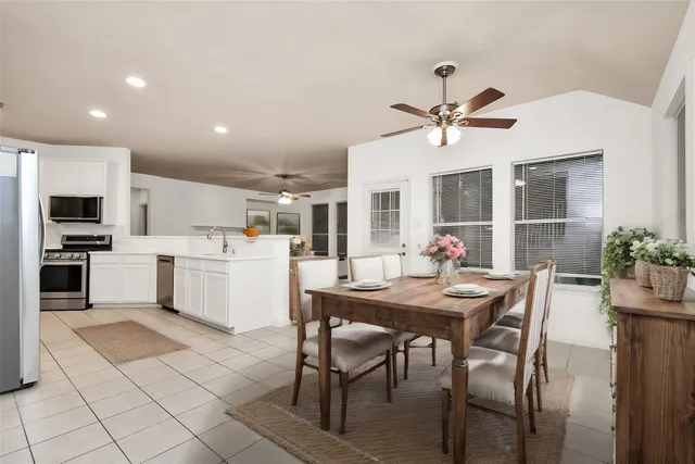 a view of a dining room with furniture and a kitchen