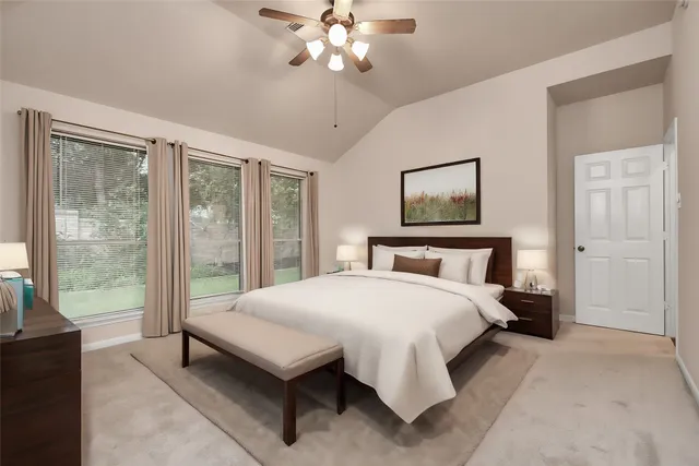 a bedroom with a large bed and a chandelier