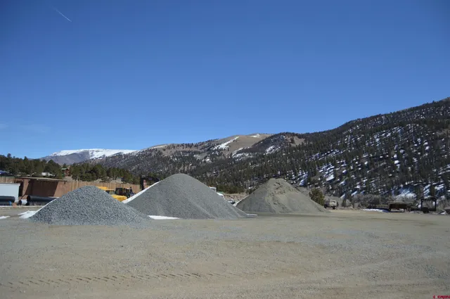 a view of a house with a balcony and yard