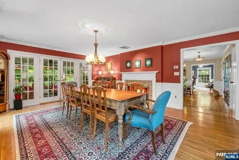 a dining room with furniture a chandelier and wooden floor