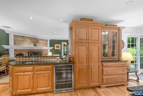 a kitchen with stainless steel appliances granite countertop a refrigerator and cabinets