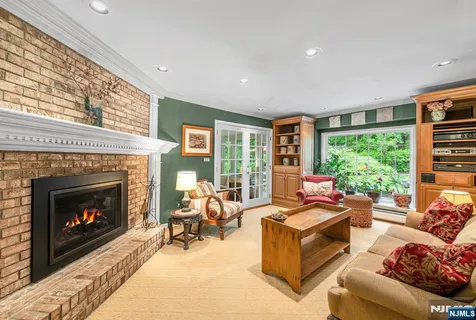 a living room with furniture large window and a fireplace
