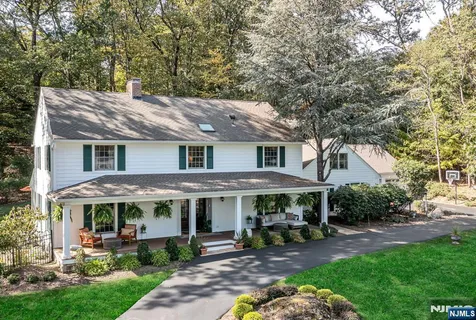 a patio with a table and chairs under an umbrella