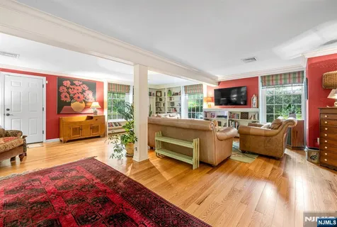 a bedroom with furniture and a flat screen tv