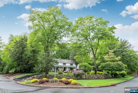 a view of house with yard and outdoor seating