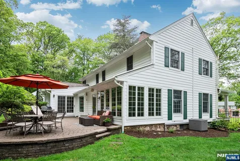a view of a house with a yard and sitting area