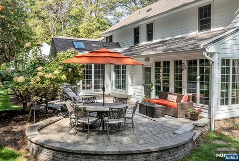 a view of a house with backyard sitting area and porch