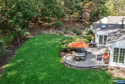 a front view of a house with a garden and plants