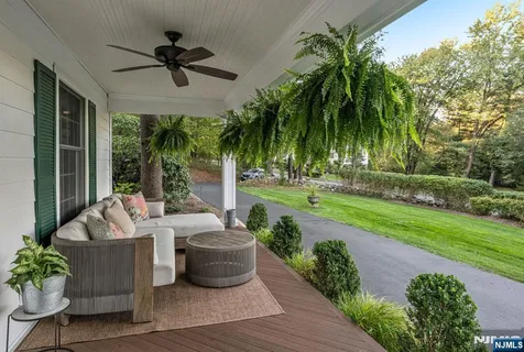 a living room with patio furniture and garden