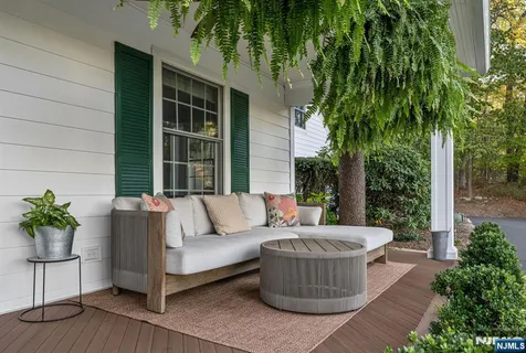 a view of a house with a couches chair and grass