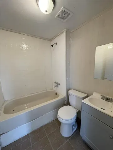 a bathroom with a toilet a sink and bathtub