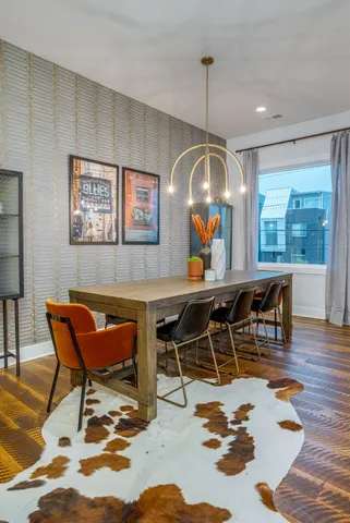 a room with table chairs and a dining table