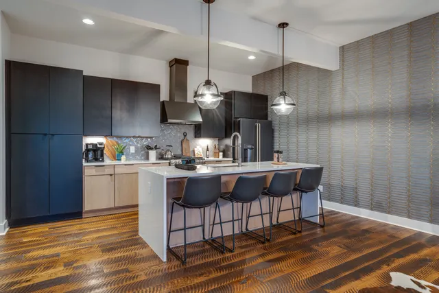 a kitchen with a sink cabinets and wooden floor