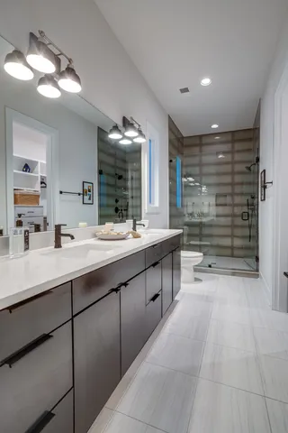 a bathroom with a double vanity sink and a mirror