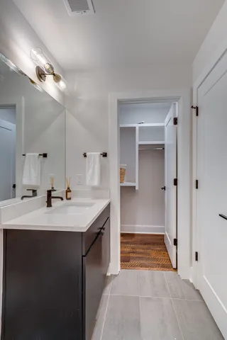 a bathroom with a sink a toilet and mirror