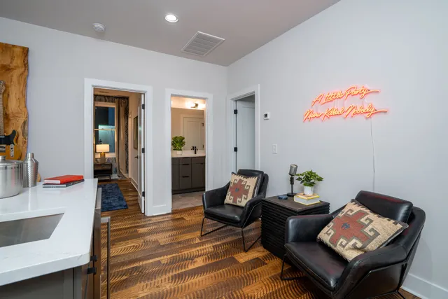 a living room with furniture and wooden floor