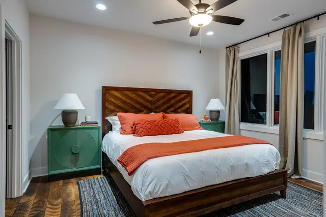 a bedroom with a large bed and a tv