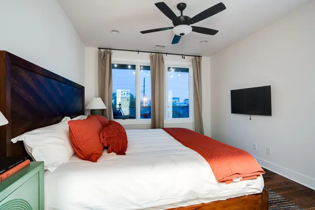 a bedroom with a bed and a flat screen tv