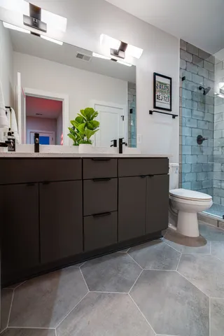 a bathroom with a toilet and a shower
