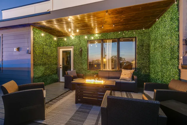 a view of a patio with couches potted plants and outdoor seating
