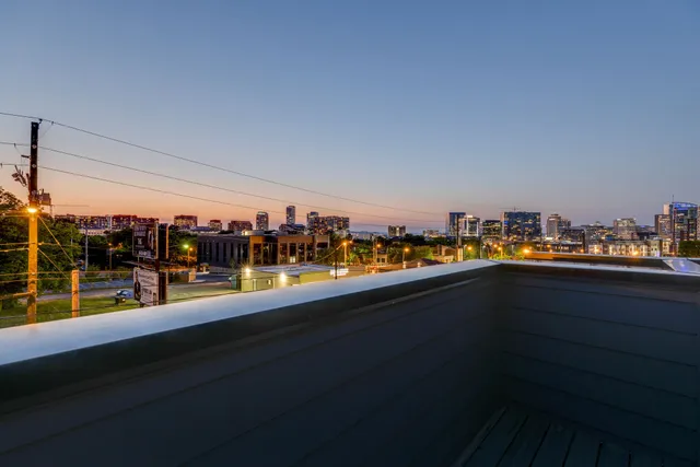 a view of a balcony with chairs and wooden floor