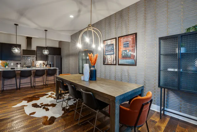 a kitchen with a table chairs and refrigerator