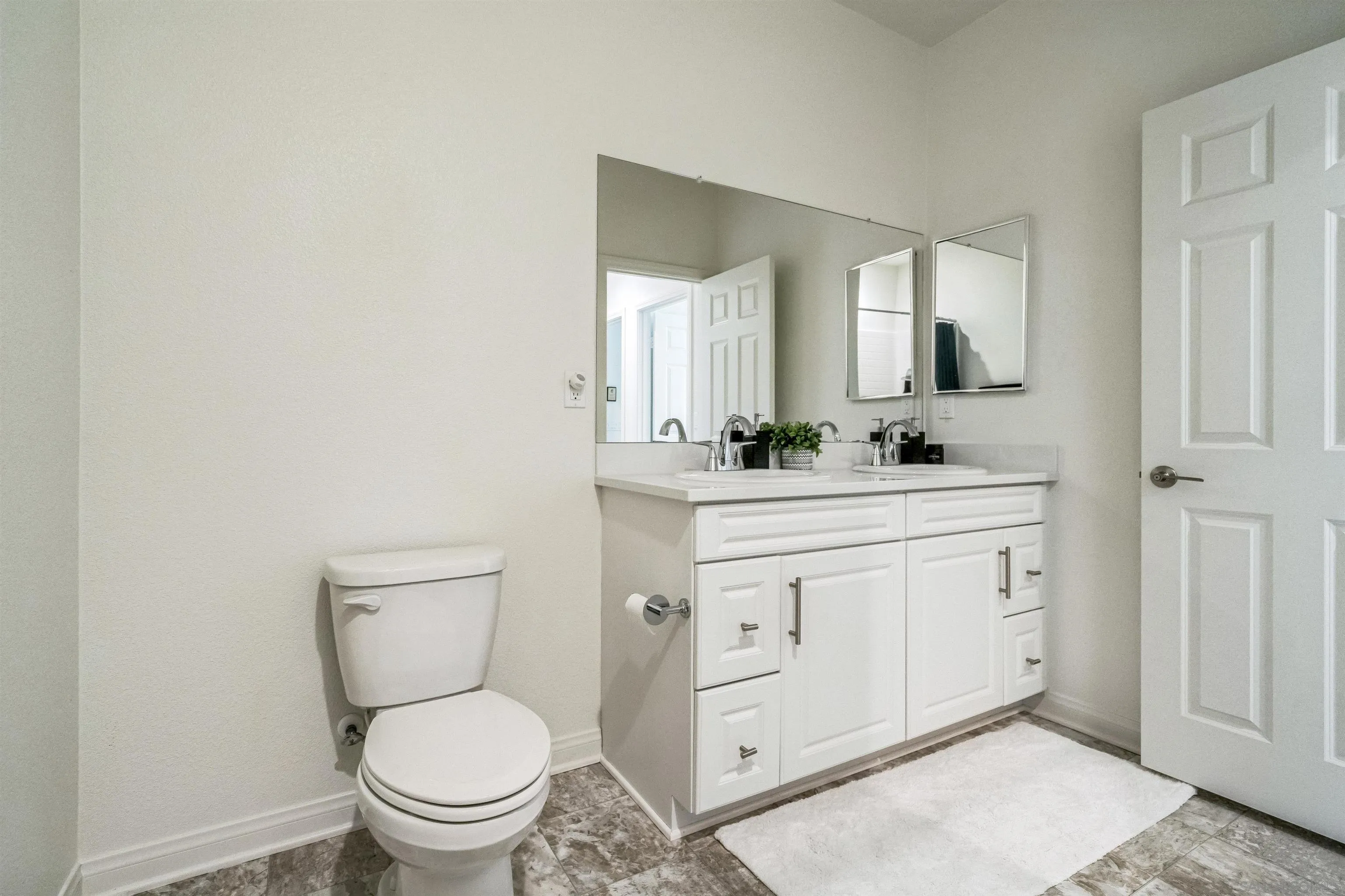 2018 Barite Street Spring Valley, CA 91977 - Photo 27 of 47 a bathroom with a toilet sink and mirror