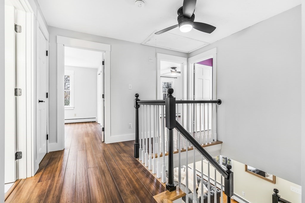 222 Middle Road Boxborough, MA 01719 - Photo 9 of 15 a view of a hallway with wooden floor and staircase