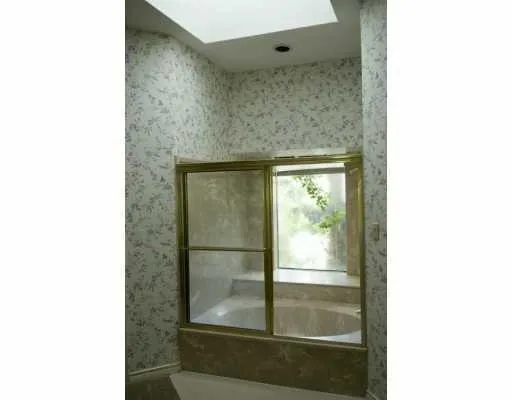 a bathroom with a glass shower door