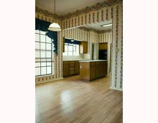 a view of kitchen with granite countertop cabinets and flat screen tv