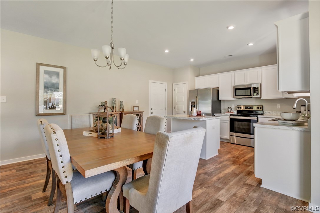 67 Chelsea Circle Aylett, VA 23009 - Photo 15 of 36 a view of a dining room with furniture and wooden floor