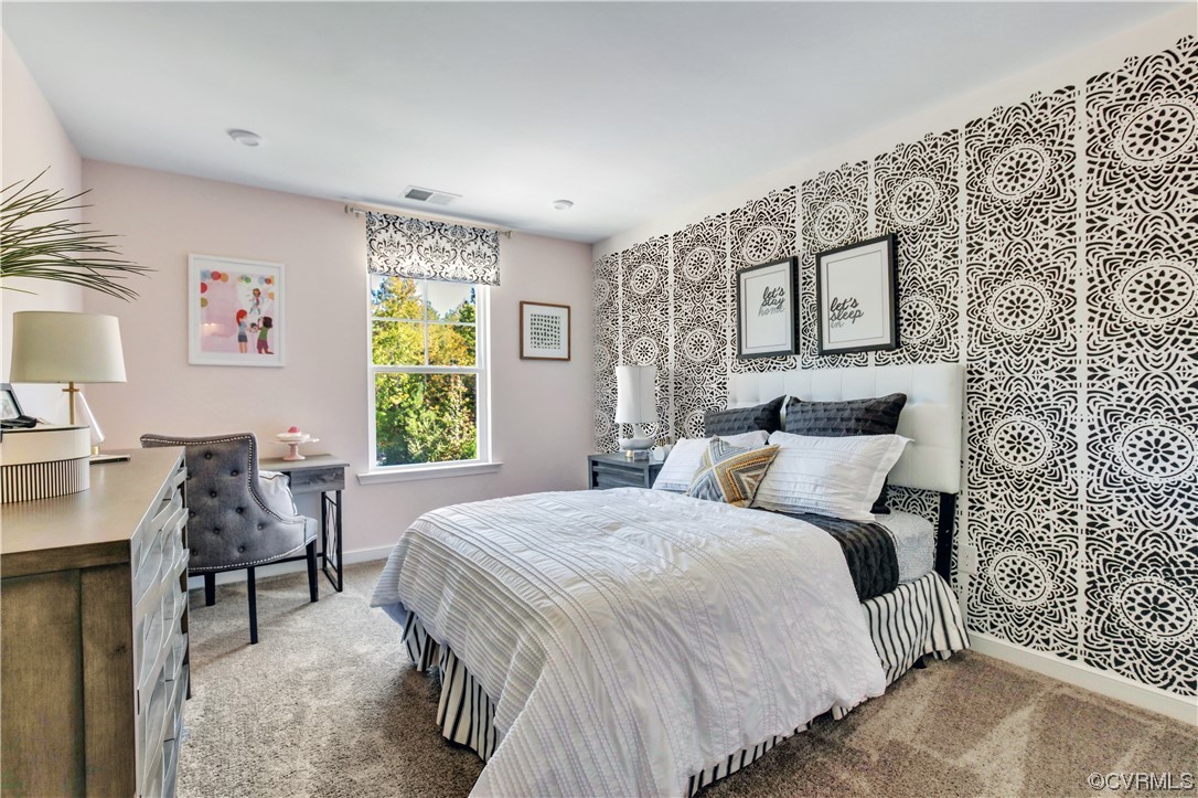 67 Chelsea Circle Aylett, VA 23009 - Photo 27 of 36 a bedroom with a bed and a table in it with window